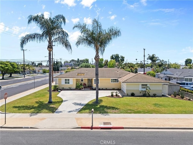 17652 Fiesta Way, Tustin, CA 92780 - single story home with a front yard, a tiled roof, concrete driveway, and stucco siding