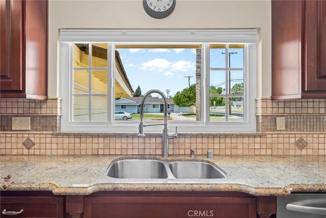 17652 Fiesta Way, Tustin, CA 92780 - kitchen featuring tasteful backsplash, dishwasher, reddish brown cabinets, and light stone countertops