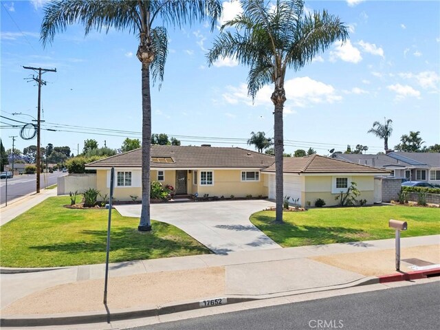 17652 Fiesta Way, Tustin, CA 92780 - single story home with driveway, a tiled roof, a front lawn, and stucco siding