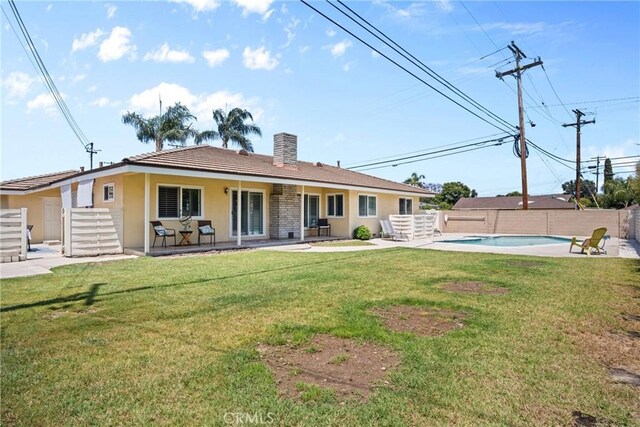 17652 Fiesta Way, Tustin, CA 92780 - rear view of property featuring a chimney, stucco siding, and a patio