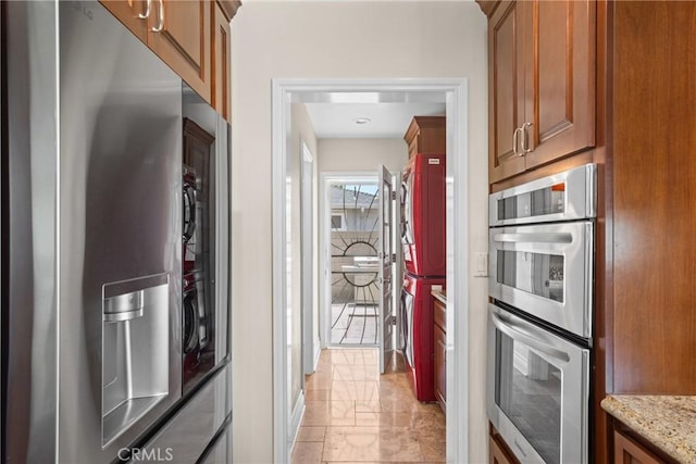 17652 Fiesta Way, Tustin, CA 92780 - kitchen with appliances with stainless steel finishes, light stone counters, and brown cabinets