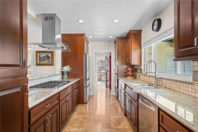 17652 Fiesta Way, Tustin, CA 92780 - kitchen with island exhaust hood, stainless steel appliances, backsplash, light stone counters, and recessed lighting