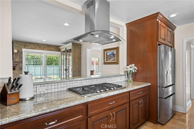 17652 Fiesta Way, Tustin, CA 92780 - kitchen with appliances with stainless steel finishes, island range hood, light stone counters, tasteful backsplash, and recessed lighting
