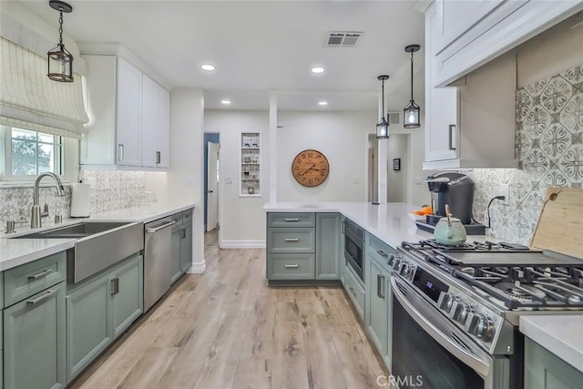 2230 Cordero Ave, Simi Valley, CA 93065 - kitchen with stainless steel appliances, a sink, light countertops, recessed lighting, and pendant lighting