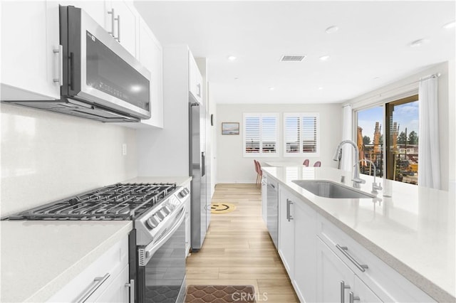 1570 Topia Ave, Placentia, Placentia, CA 92870 - kitchen with stainless steel appliances, a sink, light wood-style floors, light countertops, and recessed lighting