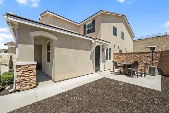 33168 Toledo Bend Ct, Winchester, CA 92596 - back of property featuring stucco siding and a patio
