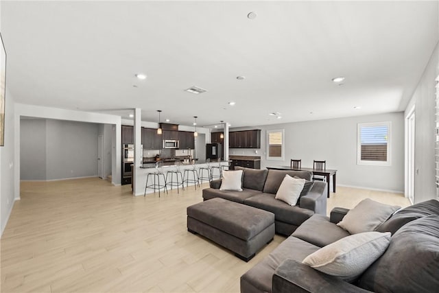 33168 Toledo Bend Ct, Winchester, CA 92596 - living room featuring light wood finished floors and recessed lighting