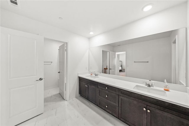 33168 Toledo Bend Ct, Winchester, CA 92596 - full bathroom with marble look tiles, double vanity, and recessed lighting