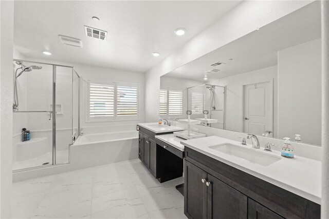 33168 Toledo Bend Ct, Winchester, CA 92596 - bathroom with marble look tile flooring, two vanities, a bath, a stall shower, and recessed lighting