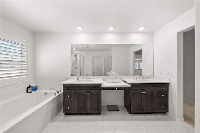 33168 Toledo Bend Ct, Winchester, CA 92596 - full bathroom with double vanity, a garden tub, marble finish floors, plenty of natural light, and recessed lighting