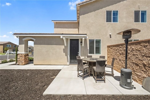 33168 Toledo Bend Ct, Winchester, CA 92596 - rear view of property featuring a patio area, stucco siding, and outdoor dining space