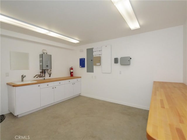 43 Oceanaire Dr, Rancho Palos Verdes, CA 90275 - kitchen featuring water heater, a sink, electric panel, white cabinets, and wood counters