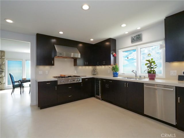 43 Oceanaire Dr, Rancho Palos Verdes, CA 90275 - kitchen featuring appliances with stainless steel finishes, a sink, wall chimney range hood, dark cabinets, and recessed lighting