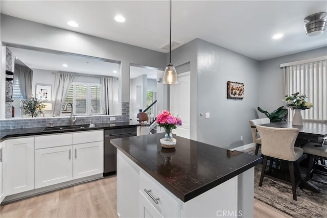 39 Windward Way, Buena Park, CA 90621 - kitchen with dishwasher, light wood finished floors, decorative backsplash, white cabinets, and recessed lighting
