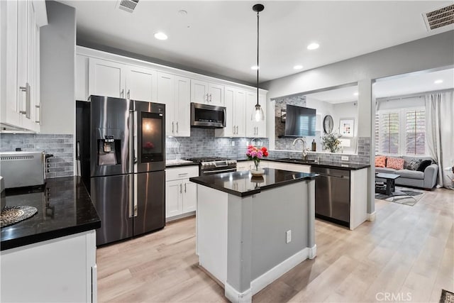 39 Windward Way, Buena Park, CA 90621 - kitchen featuring appliances with stainless steel finishes, dark countertops, light wood-type flooring, and recessed lighting