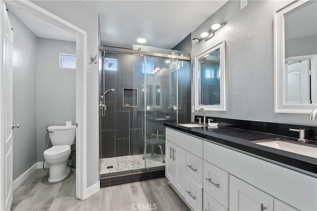 39 Windward Way, Buena Park, CA 90621 - bathroom with double vanity, a stall shower, and wood finished floors