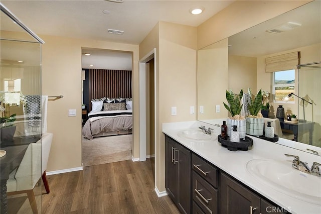 8504 Peachwillow Ct, Jurupa Valley, CA 92509 - ensuite bathroom with wood finished floors, double vanity, and baseboards