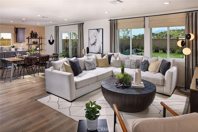 8504 Peachwillow Ct, Jurupa Valley, CA 92509 - living room with light wood-style flooring, healthy amount of natural light, and recessed lighting