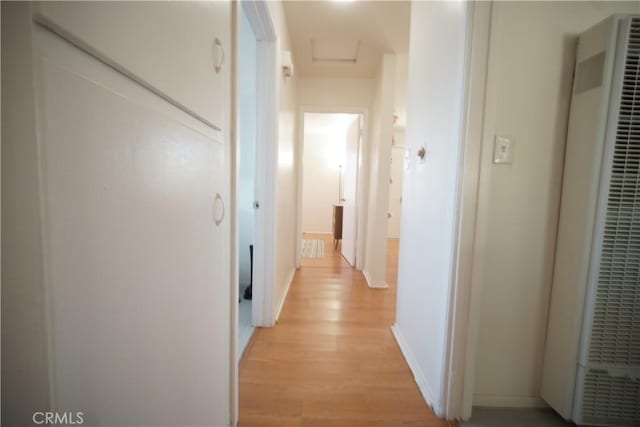 61740 Oleander Dr, Joshua Tree, CA 92252 - corridor with a heating unit, light wood-type flooring, and attic access