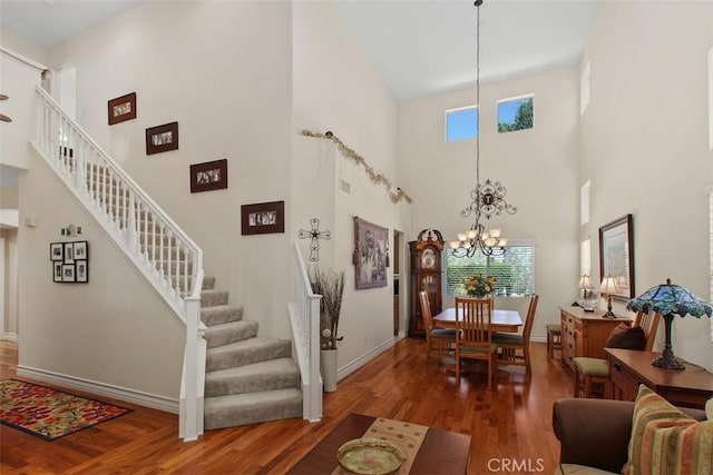 33370 Morning View Dr, Temecula, CA 92592 - living area featuring a high ceiling, wood finished floors, stairs, and a chandelier