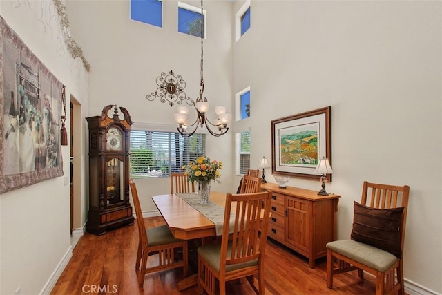 33370 Morning View Dr, Temecula, CA 92592 - dining room featuring a chandelier, wood finished floors, and a high ceiling