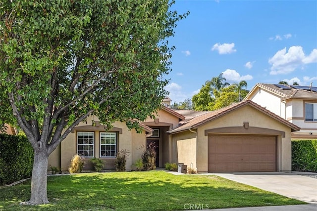 33276 Corte Yaca, Temecula, CA 92592 - view of front of home featuring an attached garage, stucco siding, driveway, and a front lawn