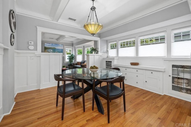 3818 Herbert St, San Diego, CA 92103 - dining area featuring a decorative wall, light wood finished floors, crown molding, wainscoting, and a fireplace