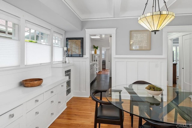 3818 Herbert St, San Diego, CA 92103 - dining area with a decorative wall, wainscoting, crown molding, and light wood-style floors