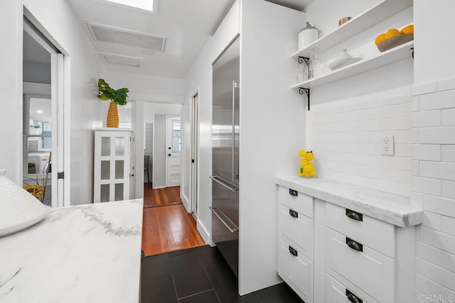 3818 Herbert St, San Diego, CA 92103 - kitchen featuring white cabinetry, built in fridge, light stone countertops, tasteful backsplash, and healthy amount of natural light