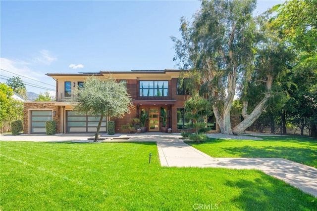 1410 Santa Margarita Dr, Arcadia, CA 91006 - view of front facade featuring roof mounted solar panels, a front yard, an attached garage, and driveway