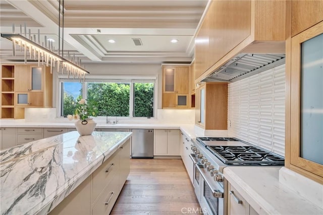 1410 Santa Margarita Dr, Arcadia, CA 91006 - kitchen featuring appliances with stainless steel finishes, light stone countertops, light wood finished floors, glass insert cabinets, and decorative backsplash