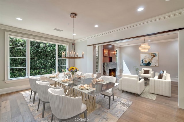 1410 Santa Margarita Dr, Arcadia, CA 91006 - dining area featuring light wood-style flooring, a lit fireplace, recessed lighting, and ornamental molding