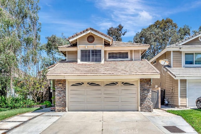 15414 Ficus St, Chino Hills, CA 91709 - traditional-style house featuring stone siding, driveway, an attached garage, and a tile roof