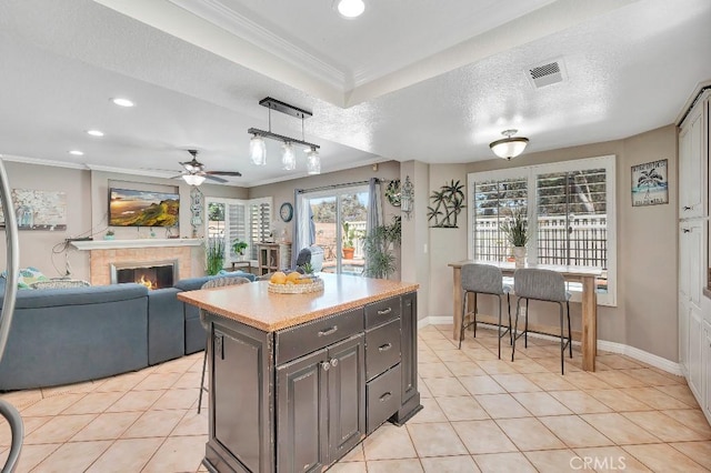 15414 Ficus St, Chino Hills, CA 91709 - kitchen featuring recessed lighting, ornamental molding, a ceiling fan, light tile patterned flooring, and a glass covered fireplace
