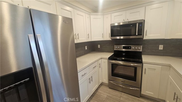 22947 Nadine Cir Unit A, Torrance, CA 90505 - kitchen featuring stainless steel appliances, white cabinetry, decorative backsplash, and light stone counters