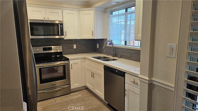 22947 Nadine Cir Unit A, Torrance, CA 90505 - kitchen with appliances with stainless steel finishes, decorative backsplash, light countertops, white cabinetry, and a textured wall