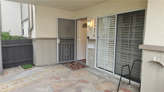 22947 Nadine Cir Unit A, Torrance, CA 90505 - view of exterior entry featuring stucco siding and a patio