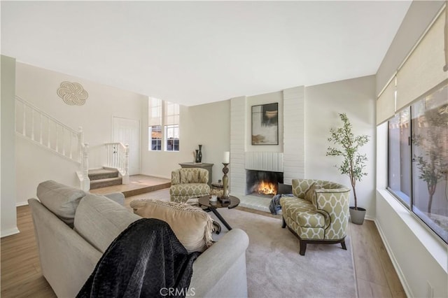 23326 Elfin Pl, Moreno Valley, CA 92557 - living area featuring stairway, a fireplace, and wood finished floors
