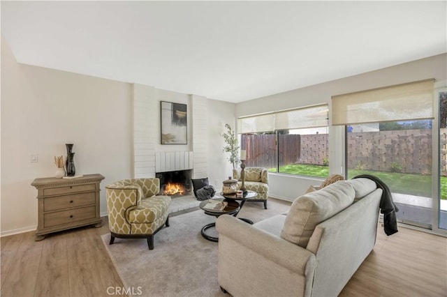 23326 Elfin Pl, Moreno Valley, CA 92557 - living room featuring a fireplace and wood finished floors