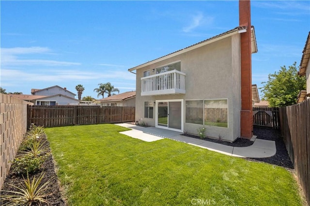 23326 Elfin Pl, Moreno Valley, CA 92557 - rear view of house featuring a balcony, stucco siding, a fenced backyard, and a patio area
