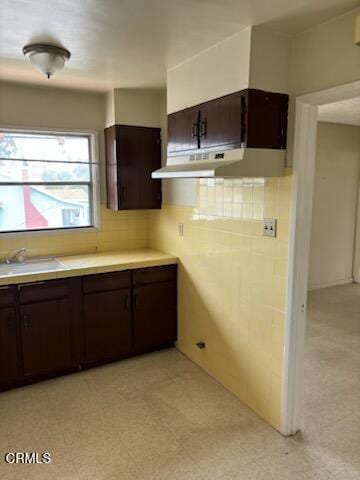 505 S Rowan Ave, Los Angeles, CA 90063 - kitchen with under cabinet range hood, dark brown cabinets, light countertops, and light flooring