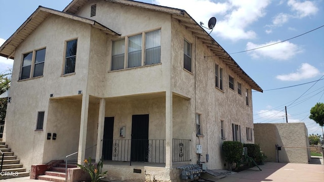 505 S Rowan Ave, Los Angeles, CA 90063 - view of front facade featuring stucco siding, covered porch, and stairway