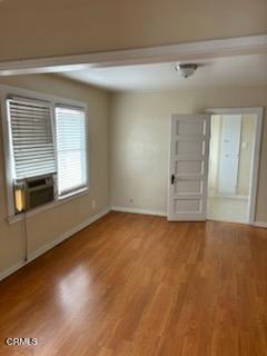505 S Rowan Ave, Los Angeles, CA 90063 - spare room featuring wood finished floors and cooling unit