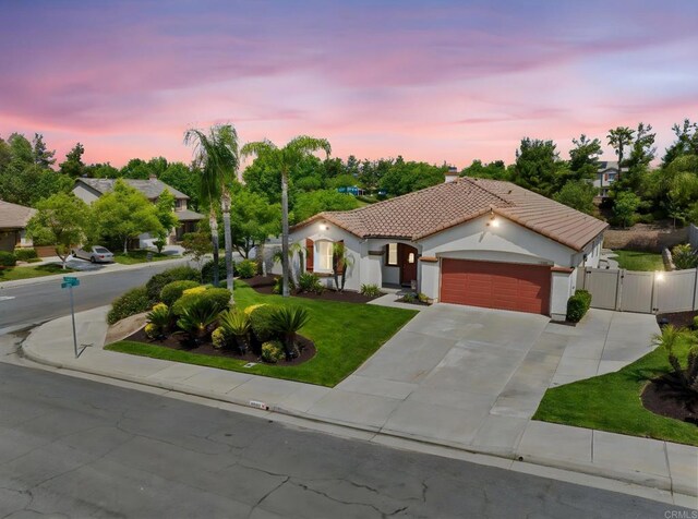 31920 Pasos Pl, Temecula, CA 92591 - mediterranean / spanish-style house with a tile roof, a gate, an attached garage, a chimney, and concrete driveway