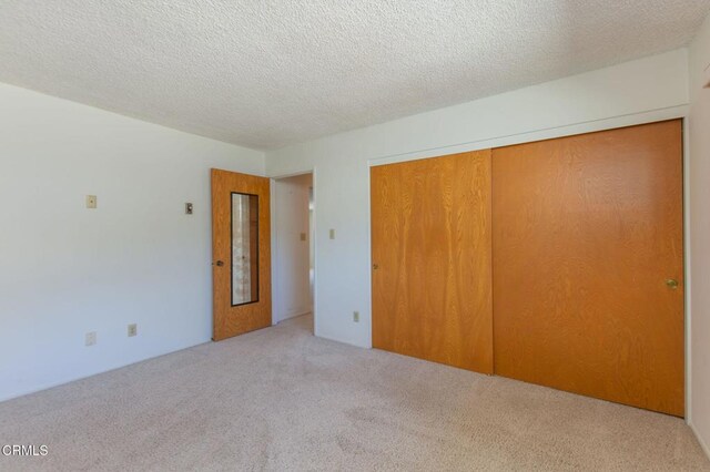4190 Ojai Rd, Santa Paula, CA 93060 - unfurnished bedroom with carpet, a closet, and a textured ceiling