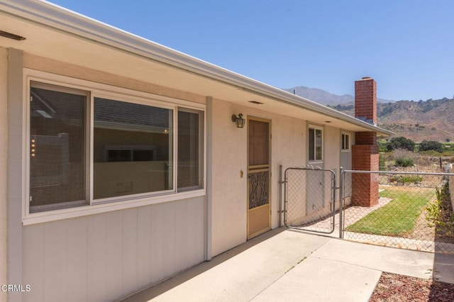 4190 Ojai Rd, Santa Paula, CA 93060 - entrance to property with a mountain view, a chimney, a gate, and stucco siding