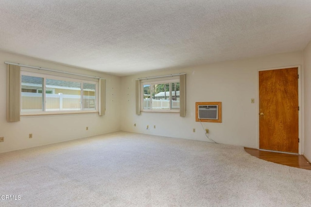 4190 Ojai Rd, Santa Paula, CA 93060 - carpeted empty room with a wall mounted AC and a textured ceiling