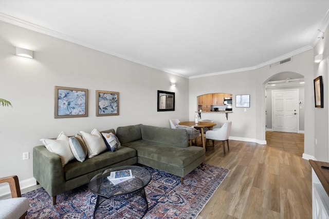 3890 Nobel Dr Unit 1505, San Diego, CA 92122 - living room featuring arched walkways, ornamental molding, and light wood-style flooring