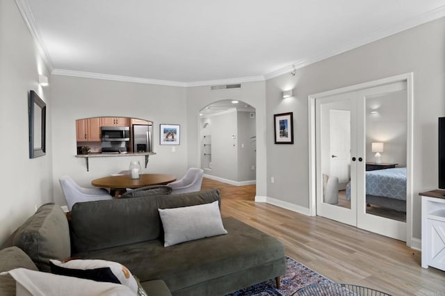 3890 Nobel Dr Unit 1505, San Diego, CA 92122 - living room with arched walkways, ornamental molding, and light wood-style flooring
