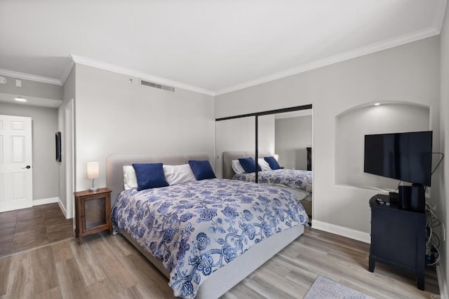3890 Nobel Dr Unit 1505, San Diego, CA 92122 - bedroom featuring crown molding, wood finished floors, and a closet